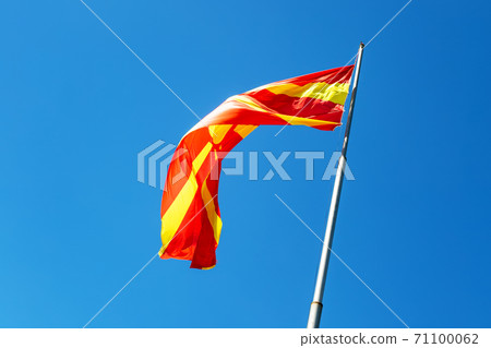 North macedonia flag waving in sunny blue sky 71100062