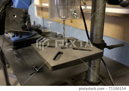Drilling machine with a drill inserted rotates. Metal drilling. 71100154
