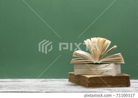 Books on wooden desk table and abstract background. Education background. Copy Space. Back to school. Books on wooden desk table and abstract background. Education background. Copy Space. Back to school. 71100317