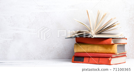 Books on wooden desk table and abstract background. Education background. Copy Space. Back to school. Books on wooden desk table and abstract background. Education background. Copy Space. Back to school. 71100365