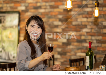 A woman relaxing at the bar 71100549