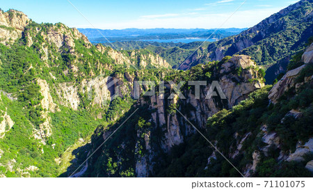 Aerial view of mountain with water reservoir on the background with beautiful blue sky Aerial view of mountain with water reservoir on the background with beautiful blue sky 71101075