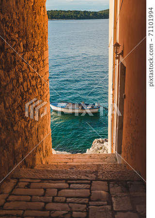 view of boat in sea through city street view of boat in sea through city street 71101994