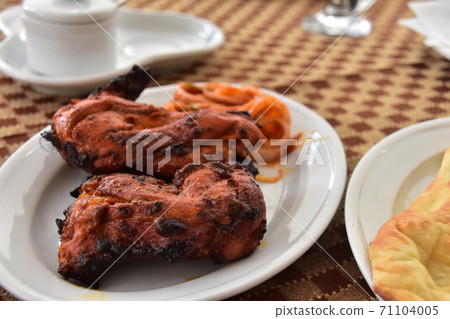 Tandoori chicken and naan eaten at Dhaka restaurant in Bangladesh Tandoori chicken and naan eaten at Dhaka restaurant in Bangladesh 71104005