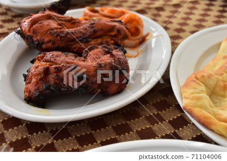 Tandoori chicken and naan eaten at Dhaka restaurant in Bangladesh Tandoori chicken and naan eaten at Dhaka restaurant in Bangladesh 71104006