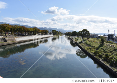 Clouds floating on the river surface of Hikone city Clouds floating on the river surface of Hikone city 71105957