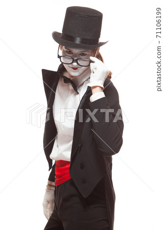 Portrait of male mime artist performing, isolated on white background. Mime lowered his glasses to look directly into eyes 71106199