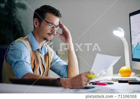 Businessman reading report Businessman reading report 71106308