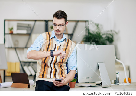 Entrepreneur checking smartwatch Entrepreneur checking smartwatch 71106335
