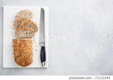 Multigrain bread sliced on a marble board 71111445