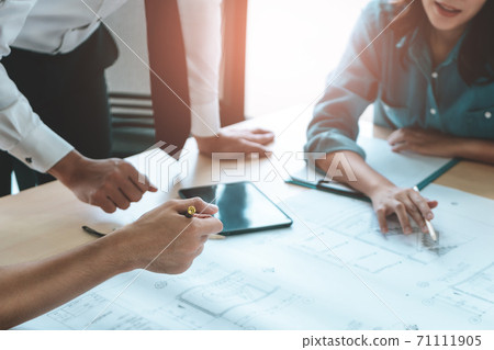 Construction team engineer and architect is brainstorming on working table with building plan Construction team engineer and architect is brainstorming on working table with building plan 71111905