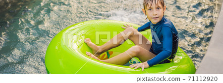 Little boy swimming with rubber ring at the leisure center BANNER, LONG FORMAT Little boy swimming with rubber ring at the leisure center BANNER, LONG FORMAT 71112920