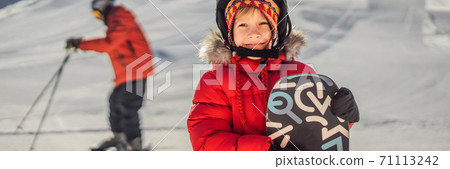 Little cute boy is ready for snowboarding. Activities for children in winter. Children's winter sport. Lifestyle BANNER, LONG FORMAT Little cute boy is ready for snowboarding. Activities for children in winter. Children's winter sport. Lifestyle BANNER, LONG FORMAT 71113242