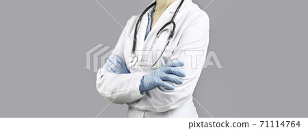 Female Doctors crossed hands. No face. grey background 71114764