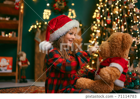 Portrait of cutel little child girl in medical mask playing with Taddy bear, New year holiday concept. Covid-19 concept Portrait of cutel little child girl in medical mask playing with Taddy bear, New year holiday concept. Covid-19 concept 71114783
