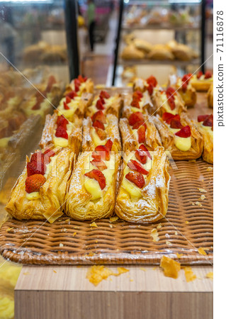 Freshly baked strawberry pastry and creamy custard at bakeshop Freshly baked strawberry pastry and creamy custard at bakeshop 71116878