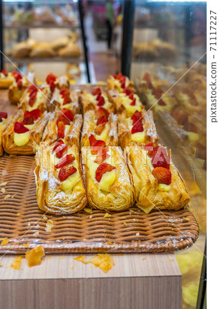 Fresh puffy pastry with strawberry for sale at bakery Fresh puffy pastry with strawberry for sale at bakery 71117227