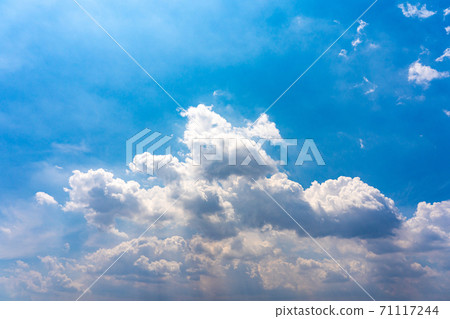 Cumulus white clouds on blue sky background with sunlight  71117244