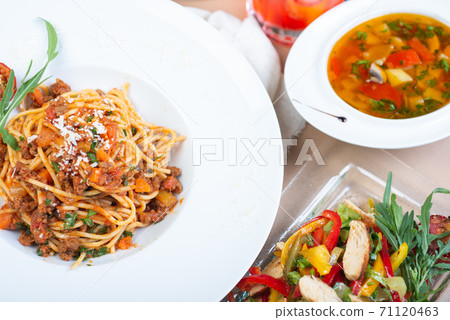 Top view of a restaurant table served with a multi-course set lunch and drink. Complex lunch. Top view of a restaurant table served with a multi-course set lunch and drink. Complex lunch. 71120463