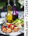 Traditional, oriental and Asian kebabs on a wooden skewer of grilled chicken pieces boiled rice as a garnish. 71120464