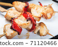 Traditional, oriental and Asian kebabs on a wooden skewer of grilled chicken pieces boiled rice as a garnish. 71120466