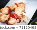 Traditional, oriental and Asian kebabs on a wooden skewer of grilled chicken pieces boiled rice as a garnish. 71120468