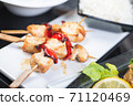 Traditional, oriental and Asian kebabs on a wooden skewer of grilled chicken pieces boiled rice as a garnish. 71120469