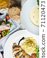 Top view of a restaurant table served with a multi-course set lunch and drink. Complex lunch. 71120473