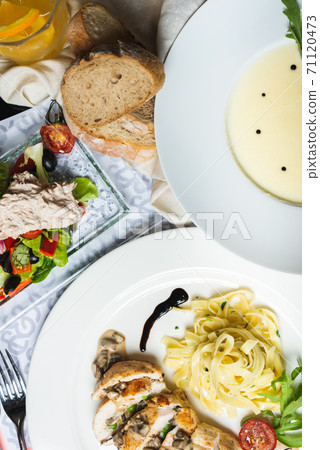 Top view of a restaurant table served with a multi-course set lunch and drink. Complex lunch. Top view of a restaurant table served with a multi-course set lunch and drink. Complex lunch. 71120473
