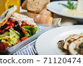 Top view of a restaurant table served with a multi-course set lunch and drink. Complex lunch. 71120474