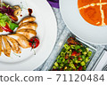 Top view of a restaurant table served with a multi-course set lunch and drink. Complex lunch. 71120484