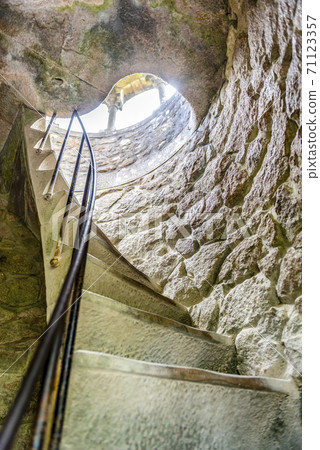 A spiral staircase in the tower in the Quinta da Regaleira park in Sintra, Portugal 71123357