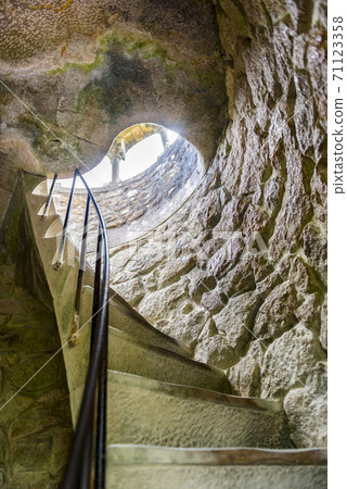 A spiral staircase in the tower in the Quinta da Regaleira park in Sintra, Portugal A spiral staircase in the tower in the Quinta da Regaleira park in Sintra, Portugal 71123358