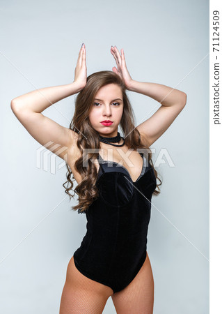 Beautiful girl dancing on a light background in fishnet pantyhose. A serious look girls 71124509