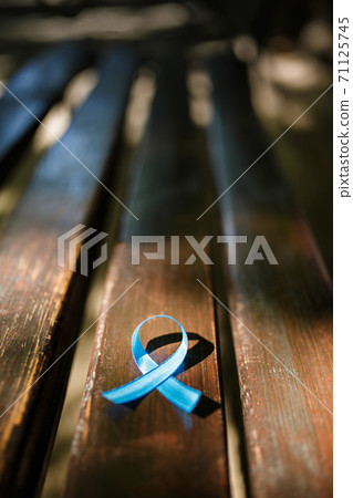 blue prostate ribbon on wooden bench 71125745