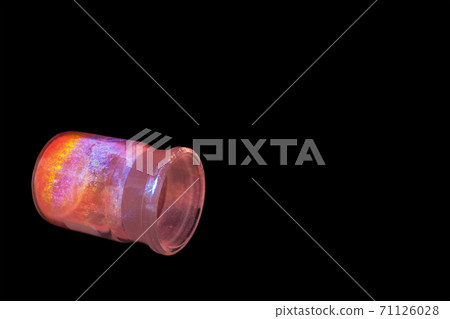 Luminescent organic materials in the form of a powder inside a glass bottle. 71126028