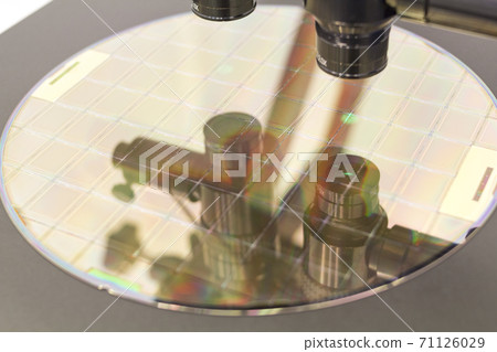 Silicon wafer on machine process examining in microscope. 71126029