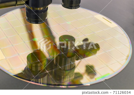 Silicon wafer on machine process examining in microscope. Silicon wafer on machine process examining in microscope. 71126034