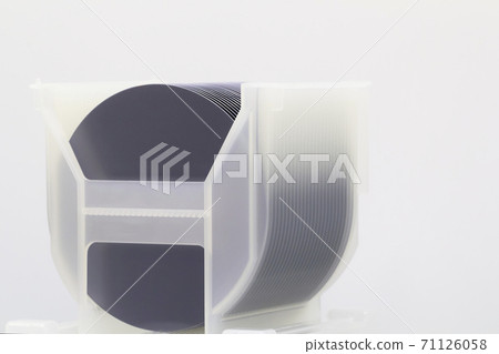 Silicon Wafers in white plastic holder box on a table- A wafer is a thin slice of semiconductor material, such as a crystalline silicon, used in electronics for the fabrication of integrated circuits. 71126058
