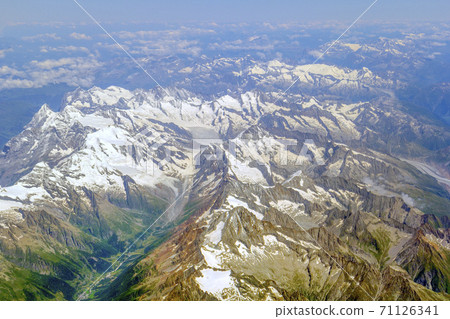 The view from the airplane window on a picturesque mountains landscape The view from the airplane window on a picturesque mountains landscape 71126341