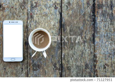Smartphone and Coffee cup made of paper on old wood desk on top view. Smartphone and Coffee cup made of paper on old wood desk on top view. 71127951
