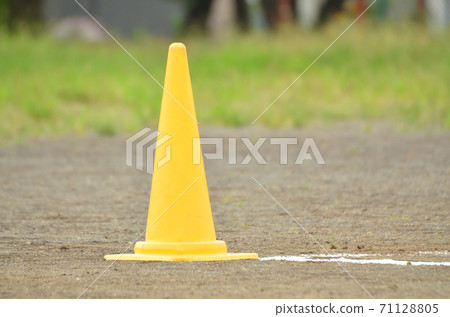 Yellow pylon placed on the ground 71128805