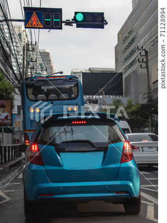 Cars stand at semaphore lights in the city streets. Traffic in downtown Bangkok, Thailand. 71128994