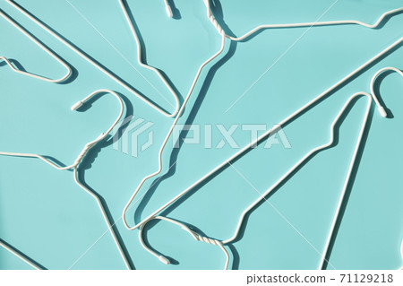 White metal hangers on pastel background White metal hangers on pastel background 71129218