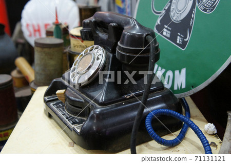 SEREMBAN, MALAYSIA -JUNE 5, 2020: Antique pull dial round phones are on display for sale at the pawn shop. The phone is still in its original condition and well maintained. 71131121