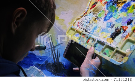 Artist copyist paint seascape with ship in ocean. Craftsman decorator draw as boat sail on blue sea. In hand of cellphone tablet computer pc. Artist copyist paint seascape with ship in ocean. Craftsman decorator draw as boat sail on blue sea. In hand of cellphone tablet computer pc. 71131218