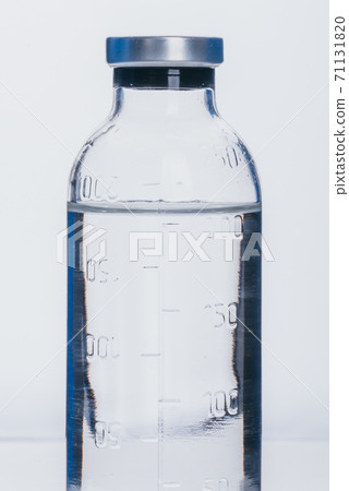 Glass medical ampoule vial for injection. Medicine is dry white drug penicillin powder or liquid with of aqueous solution in ampulla. Close up. Glass medical ampoule vial for injection. Medicine is dry white drug penicillin powder or liquid with of aqueous solution in ampulla. Close up. 71131820