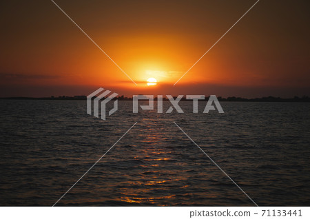 Sunset over the sea lake bay. Low key 71133441