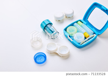 Composition with contact lenses and accessories on white background 71133528