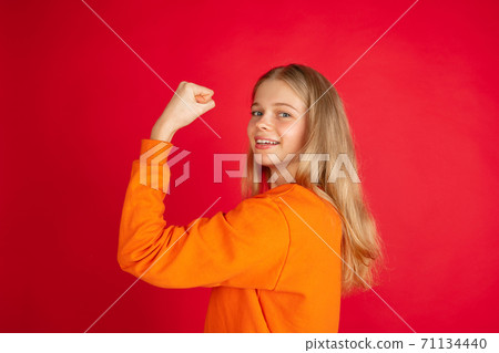 Portrait of young caucasian woman with bright emotions isolated on red studio background Portrait of young caucasian woman with bright emotions isolated on red studio background 71134440